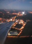 SX32639 Airplane wing over town lights.jpg